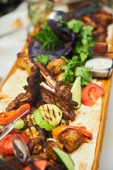 There is a plate of barbecue food on the table. Barbecue and vegetables. It looks delicious
