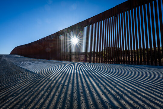 border wall fading into horizon