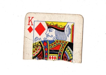 A torn half of a well used vintage playing card on a white background.
