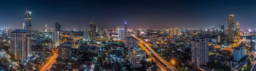 Fototapeta premium Top view of the expressway, highlighting road traffic as crucial infrastructure, an urban cityscape symbolizing cutting-edge innovation, financial technology, energy power, and the expressway