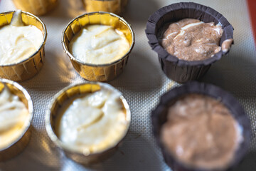 Baking process of chocolate vanilla cupcake dessert, meditation, healthy organic low sugar diet, small bakery, home baking, self care and happiness, batter in stainless steel spoon