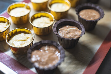 Baking process of chocolate vanilla cupcake dessert, meditation, healthy organic low sugar diet, small bakery, home baking, self care and happiness, batter in stainless steel spoon