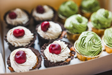 Chocolate cherry and matcha flavored cupcakes, exquisitely packaged in paper boxes, small baking business, organic low sugar cakes for parties and gatherings,cream top