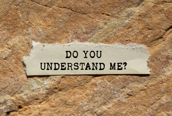 Do you understand me message written on ripped torn  paper on stone background. Conceptual do you...