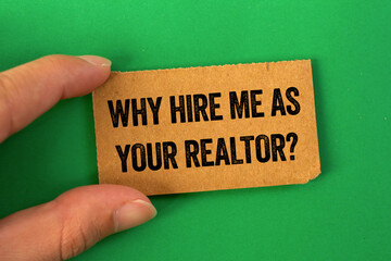 Why hire me as your realtor message written on cardboard paper on green background. Conceptual why...