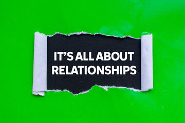 It&rsquo;s all about relationships message written on ripped torn green paper on black background. Conceptual it&rsquo;s all about relationships symbol. Copy space.