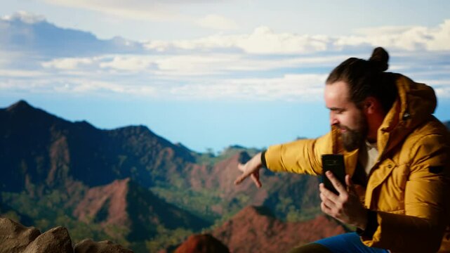 Clumsy mountain hiker dropping his phone due to lack of attention, unequipped traveler defocusing and being reckless. Modern person in the nature obsessed with technology. Camera B.
