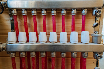 Naklejka premium In this image, we can see a closeup view of a heating system that features distinct red pipes along with white caps, showcasing the intricate design and components involved