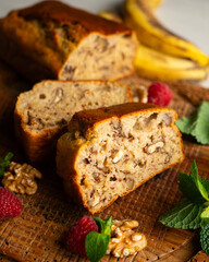 Delicious piece of banana and walnut cake on a rustic wooden base.