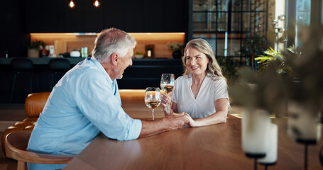 Cheers, holding hands and mature couple with champagne in home for celebration, romance and...