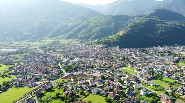Aerial view of the town of Borgo Valsugana amidst the greenery of the mountains. Wonderful valley in Trentino, Italy