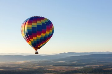 vibrant hot air balloon soars above scenic landscape on crisp clear morning with ample copy space