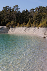 Limestone lake with beautiful clear water and trees on a sunny day in spring on Gotland