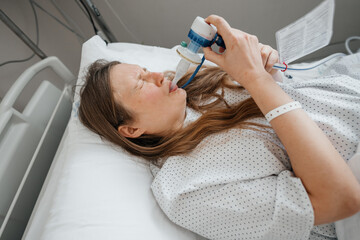 Pregnant Woman Using Gas and Air for Pain Relief During Labor