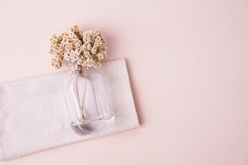 Flower vase and dried flowers on beige background