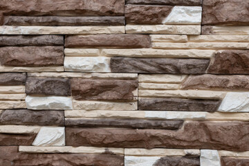 Variety of textured stone wall with neutral colors showcasing craftsmanship in architectural design