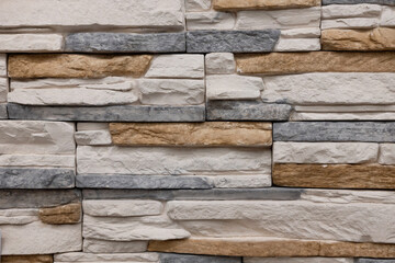 Variety of textured stone wall with neutral colors showcasing craftsmanship in architectural design