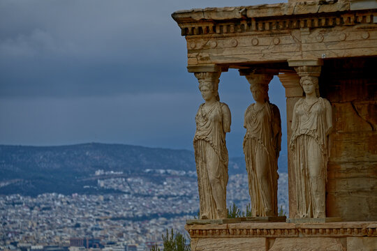 Close-up view of the famous Caryatid Porch of the Erechtheion temple on the Acropolis in Athens, Greece. The iconic sculpted female columns and classical marble architecture showcase the artistic achi