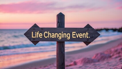 A wooden signpost pointing toward the ocean, labeled 'Life Changing Event' at sunset, with soft waves and pastel skies