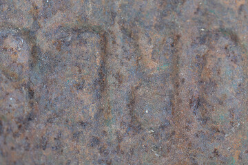A close-up of rusted iron texture, showcasing rich orange-brown hues, flaky oxidation, and corroded patterns. The rough, weathered surface highlights natural decay and aging.