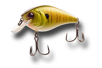 Artificial fishing lure with shadow below that is yellow and gold with two treble hooks isolated on a transparent png.