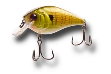 Artificial fishing lure with shadow below that is yellow and gold with two treble hooks isolated on a transparent png.