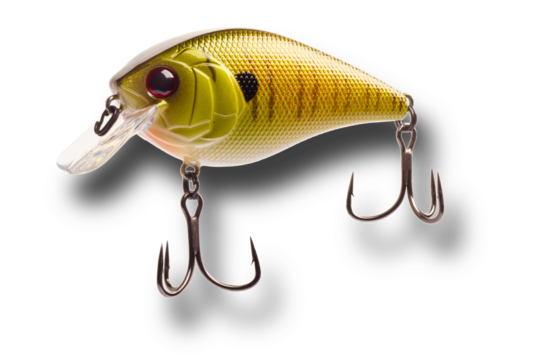 Artificial fishing lure with shadow below that is yellow and gold with two treble hooks isolated on a transparent png.