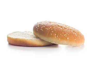 Empty burger bun with sesame seeds isolated on white background.
