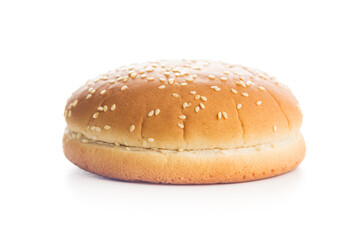 Empty burger bun with sesame seeds isolated on white background.