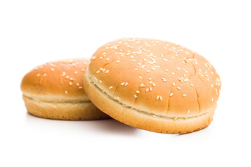 Empty burger bun with sesame seeds isolated on white background.