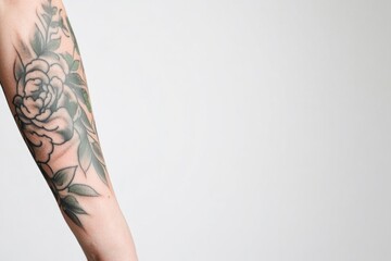 close-up of intricate tattoo designs on forearm against plain white background featuring prominently detailed and artistic