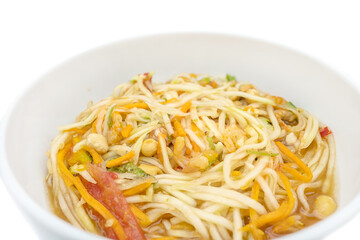 Som Tum Thai Bowl of Green papaya salad with shrimp, peanuts, lime, tomatoes Traditional Thai food in wooden bowl
