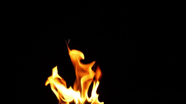 closeup of a single fire flame texture isolated on black background, normal speed, motion design element template overlay decoration