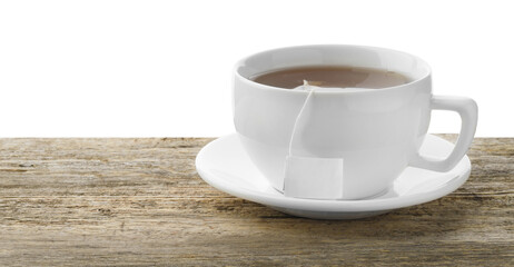 Tea bag in cup with hot drink on wooden table against white background