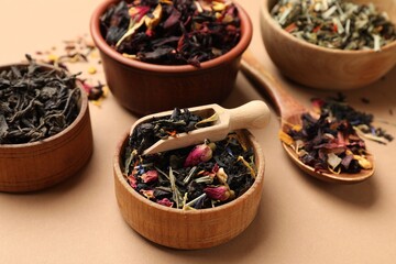 Different types of tea brew on brown background, closeup