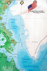 Greenland with the American flag on the world map. The US wants to buy Greenland. Space for text. © kosoff