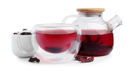 Delicious hibiscus tea in glass cup, teapot and dry roselle sepals isolated on white