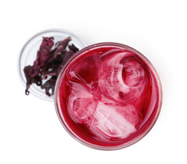 Delicious hibiscus tea with ice in glass and dry roselle sepals isolated on white, top view