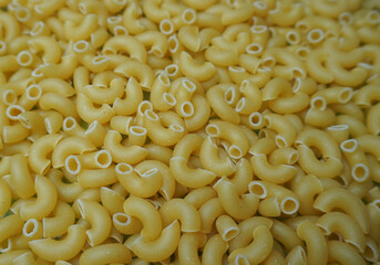 Pasta cones are large.Close-up of pasta in the form of horns. The fresh, dry, golden-colored pasta is ideal for cooking delicious dishes.