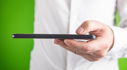 Male hand showing black mobile phone.
