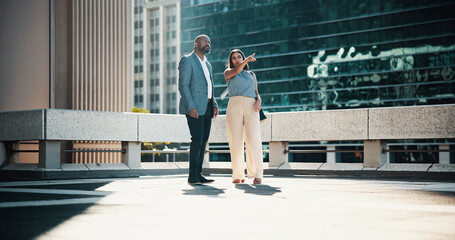 Collaboration, pointing and talking with business people in city for planning or vision together....