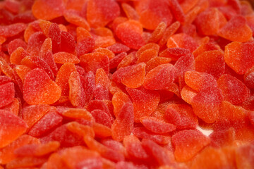 Pile of red and orange, sour jelly beans in a candy store