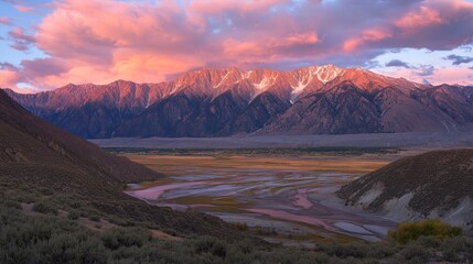 Naklejka premium Majestic Mountain Range at Sunrise Over Valley River