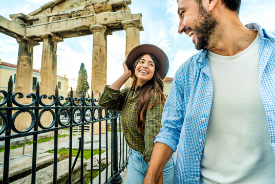 Fototapeta Happy couple in love visiting Athens, Greece - Two young tourists walking in Rome city streets, Italy - Weekend holidays and summertime vacation concept