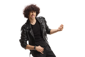 Cheerful young man in a leather jacket playing air guitars