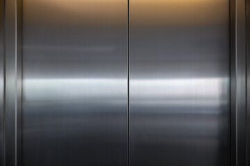 The silver doors of an elevator are closed