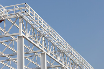 A white building with a blue sky in the background