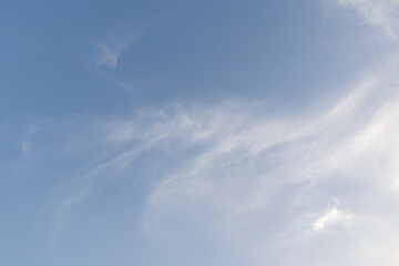 A clear blue sky with a few clouds