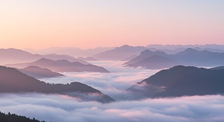 Obraz premium A pastel sunrise illuminates layers of misty mountains, creating a serene and ethereal landscape with a dreamlike, atmospheric perspective effect.