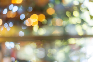 Fototapeta premium ange bokeh lights background,Blurred orange bokeh background. Blur abstract background of urban light. Warm light with beautiful pattern of round bokeh. Orange light in the night. Street lamp blurred 